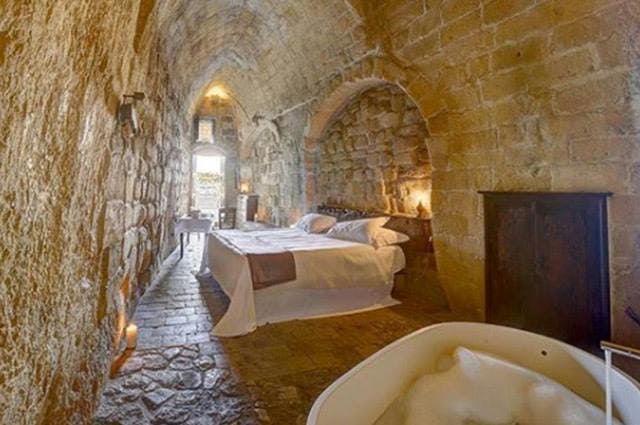 An old stone building which has been converted into a rental property. With traditional features including stone archway and fireplace 