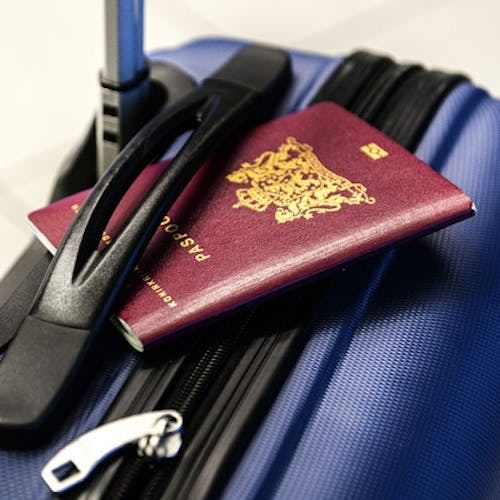 Close up of a passport sitting on luggage