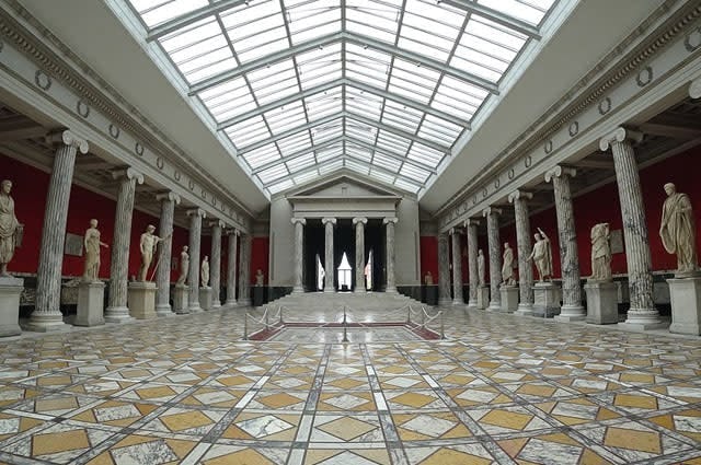 One of the gallery rooms showcasing stone statues in Glyptotek Museum 