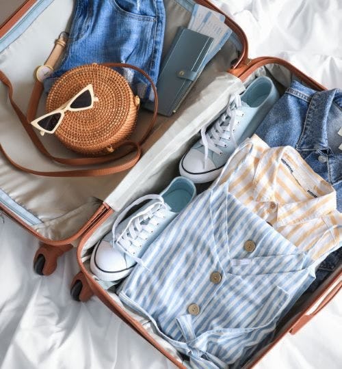 Suitcase open with clothes inside