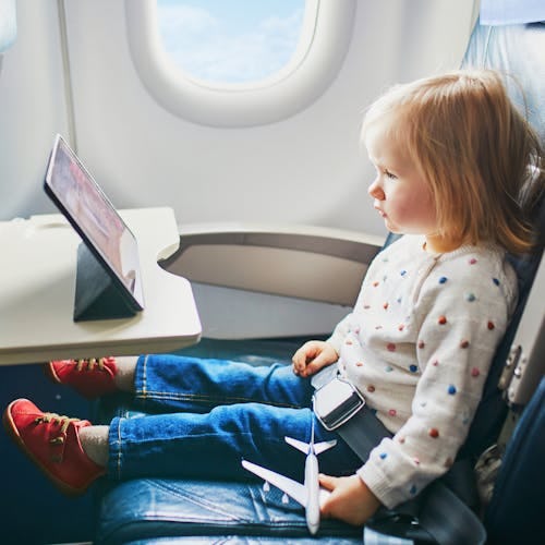 A toddler keeping entertained on a flight