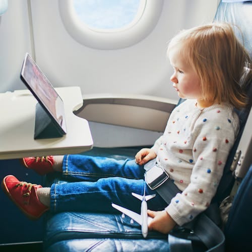 A toddler keeping entertained on a flight