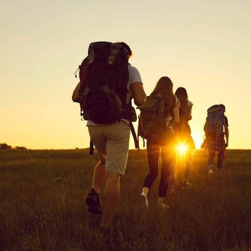 people backpacking together