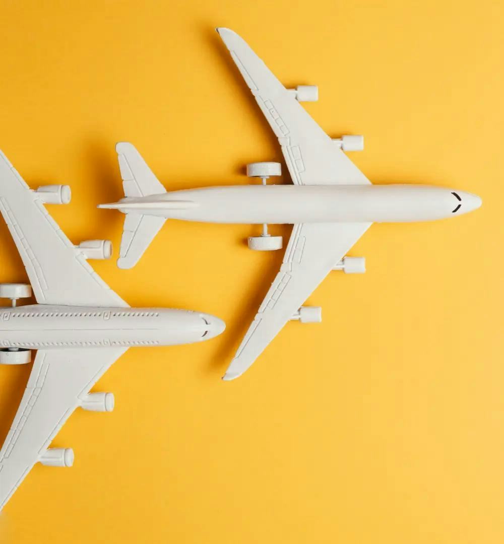 Two model planes with a yellow background
