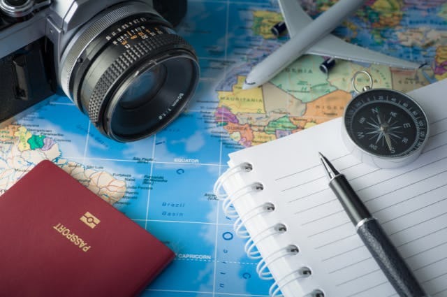 A map with a camera, passport and notebook