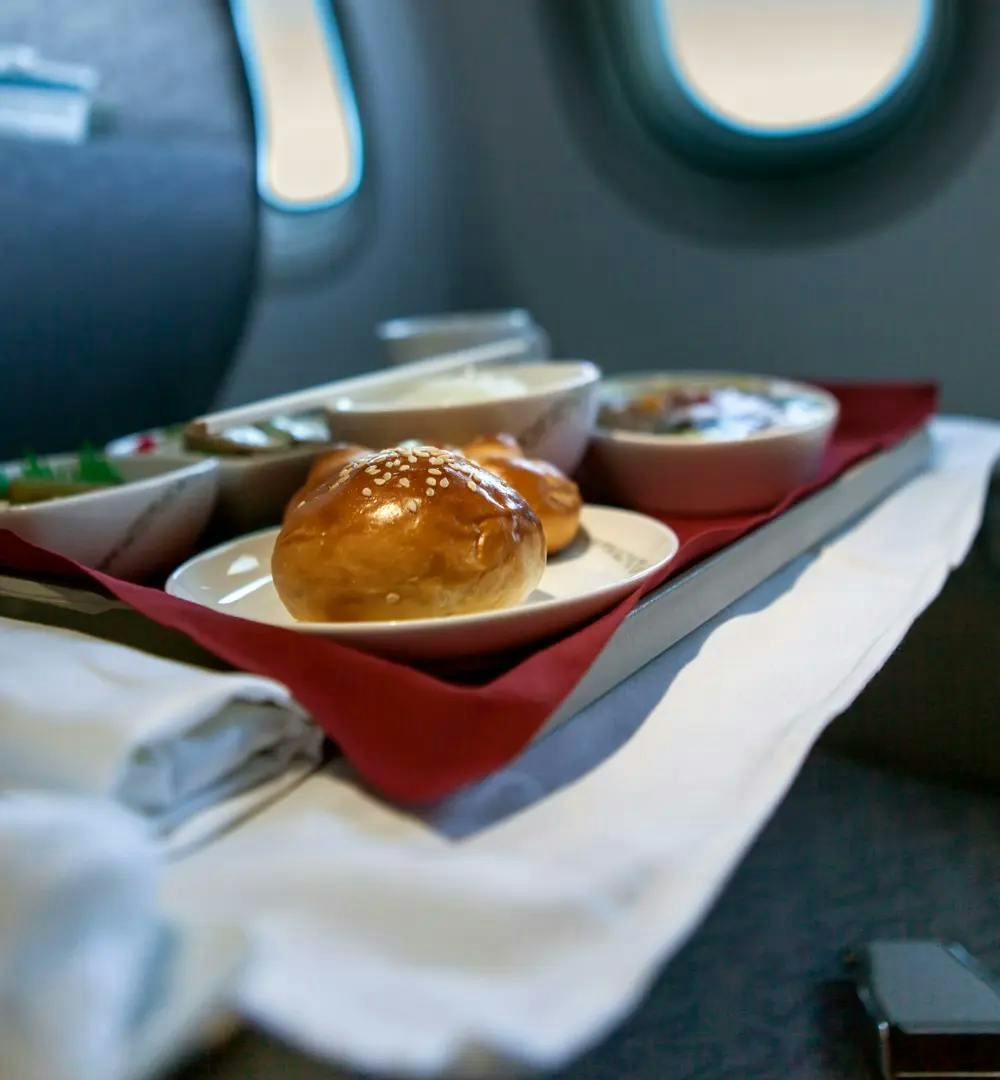 A halal inflight meal featuring a bread roll in focus.