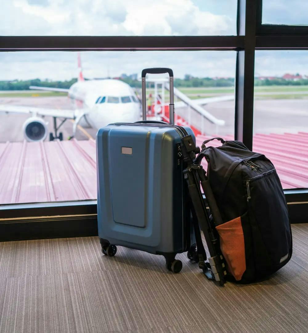 Suitcases in front of airplane in airport
