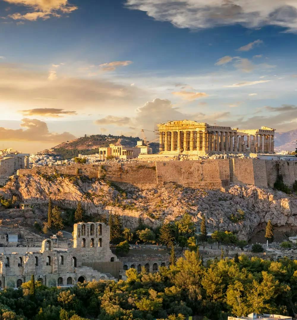 A wide shot of the Parthenon and surrounding buildings in Athens, Greece.