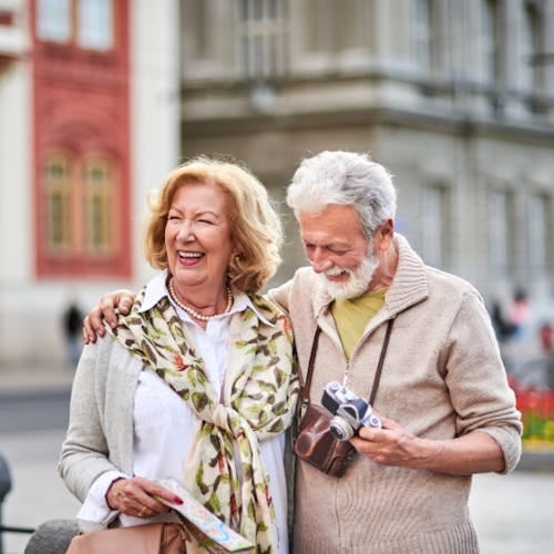 A senior couple laughing while travelling