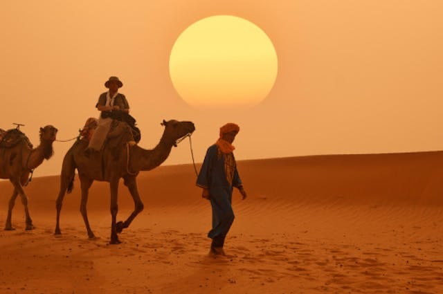 Camel riders in a desert in saudi