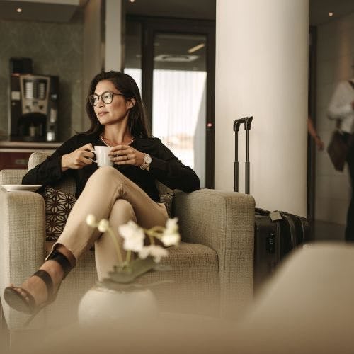 Woman sitting in a first class airport lounge