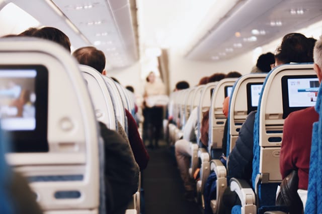 Picture of the aisle inside an airplane cabin