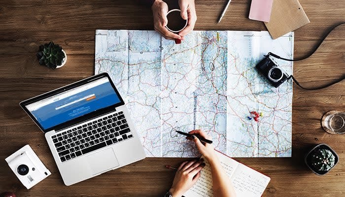 People planning their travel plans on a map 