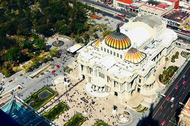 The culturally significant Teatro Bellas in Mexico City with an orange domed roof and white fascade 