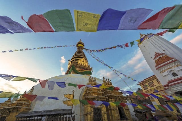 Buddhist temple in Nepal with flags flying 