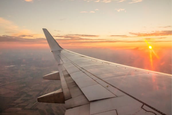 Plane wing view of sunset