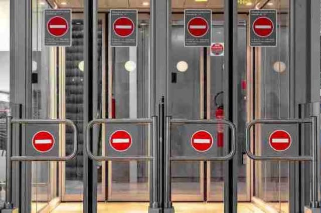 Airport security gates with 'do not enter' signs