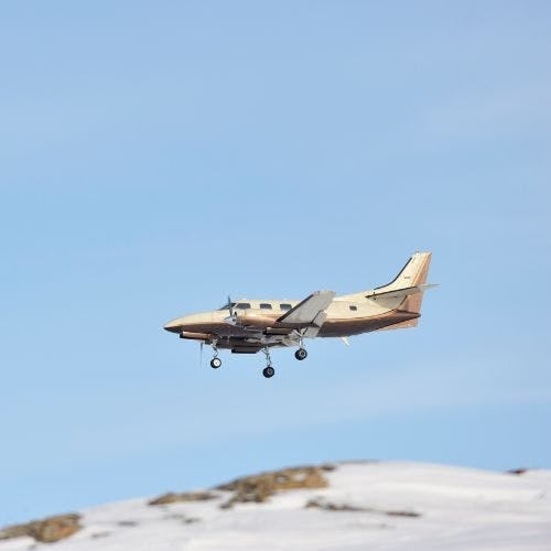 Prop plane flying over Baffin Island