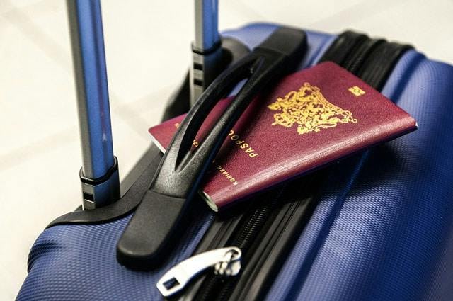 Close up of a passport sitting on luggage