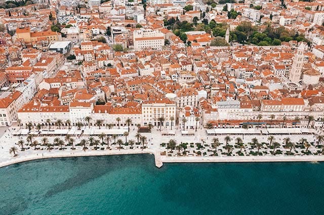 Orange topped houses line the promenade of Split next to the deep blue sea
