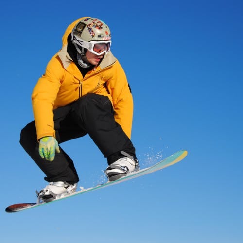 Person doing a jump on a snowboard