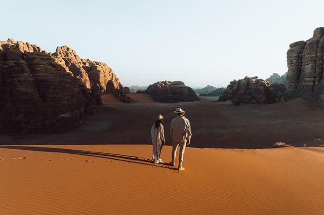A woman and a man looking out to the desert in Neom, Saudi Arabia