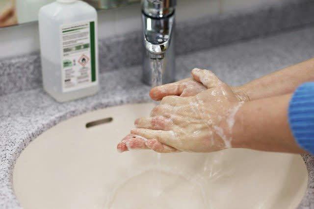 Person washing their hands 