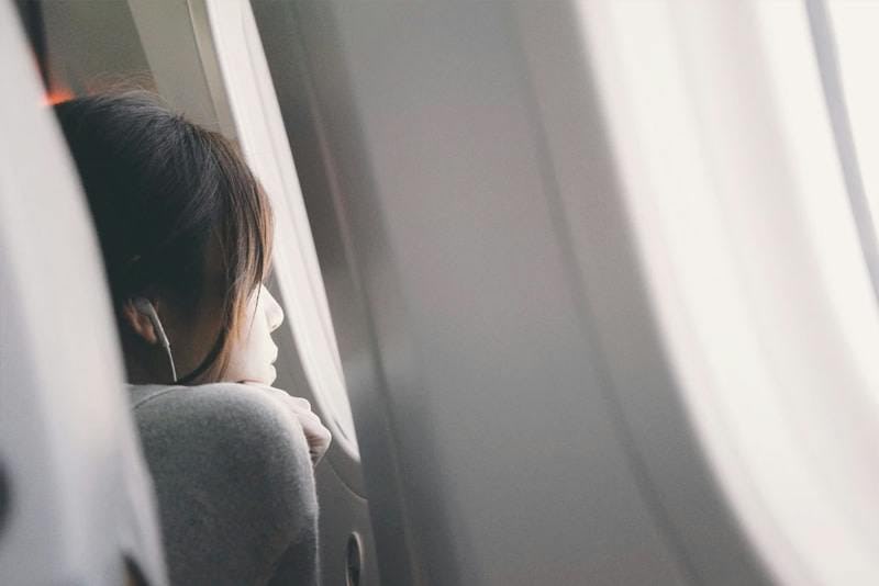 Woman looking out the window of the plane