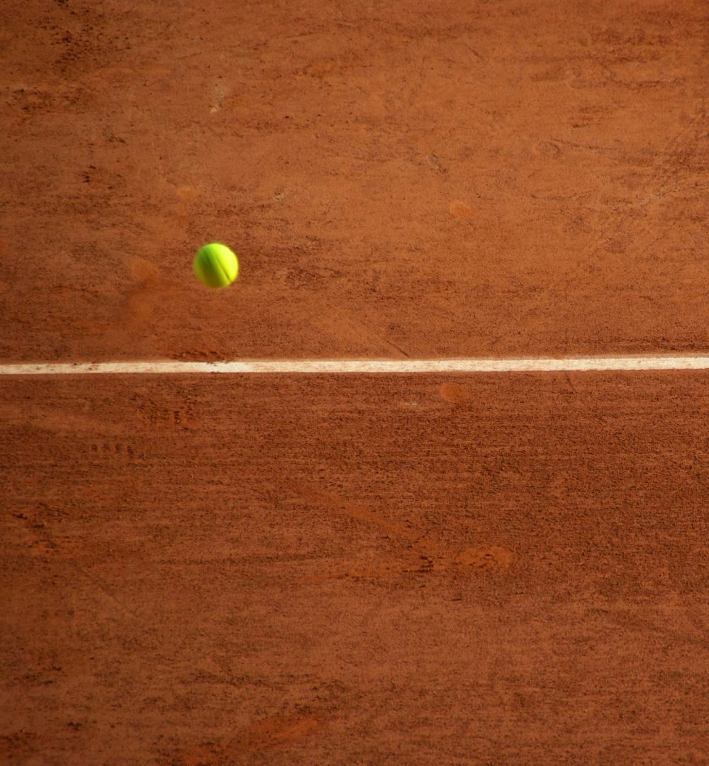 A tennis ball on the clay court at Stade Roland-Garros