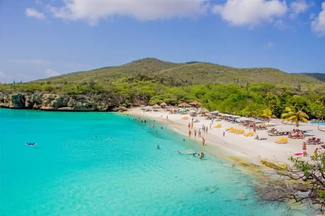 Holiday makers swimming in the turquoise waters of Curacao