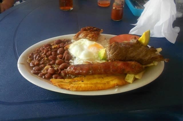 Close up photo of a meal, including beans, sausage and egg
