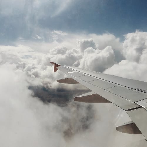 Plane Wing Over Cloudy Sky
