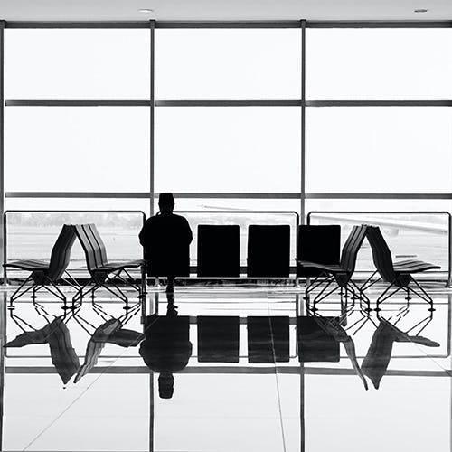Picture of a man sitting alone in an airport lounge