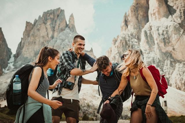 A group of friends laughing whilst hiking the dolomites