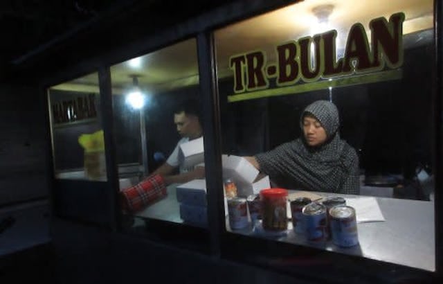 A street food vendor in Bali, Indonesia, taken at night. The stall is entitled 'TR-Bulan'. 