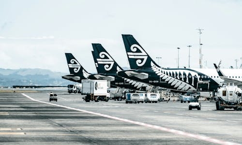 Row of Air New Zealand aircrafts at airport