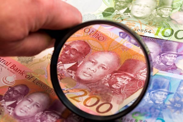 Lesotho Loti bank note under magnifying glass