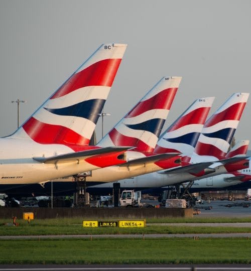 Row of British Airways planes at airport