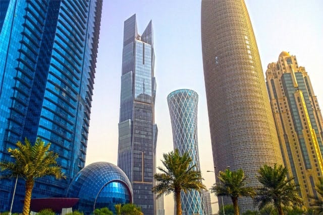 The futuristic city skyline of Doha at golden hour 