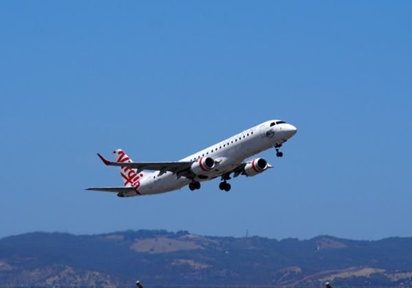 Virgin airline taking off into blue skies