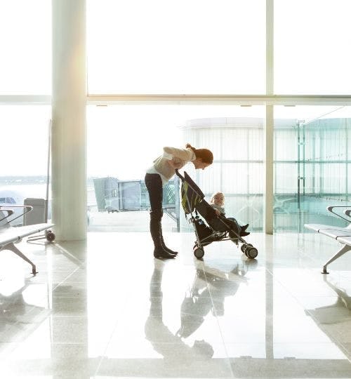 A mother and baby in an airport terminal