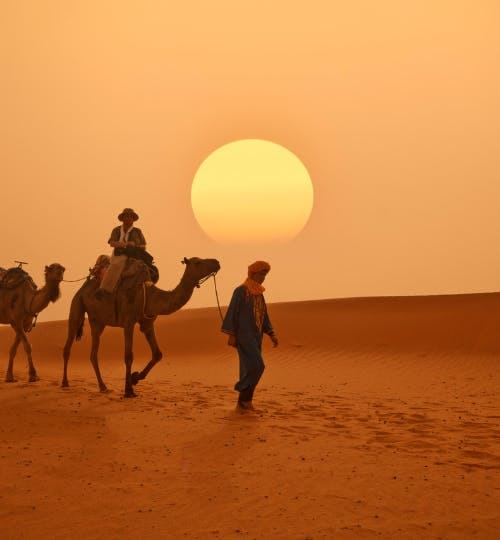 Camel riders in a desert in Morocco