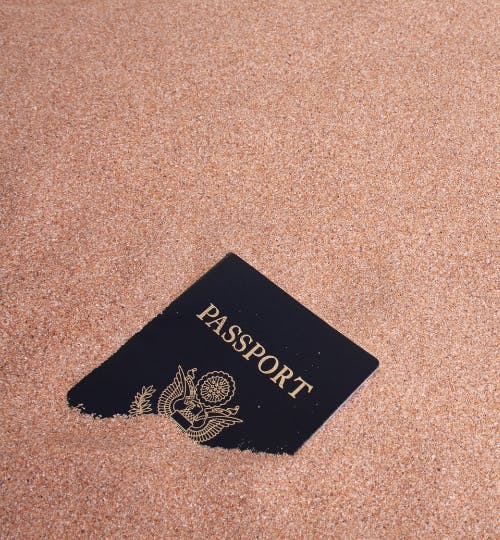 A passport buried in some sand