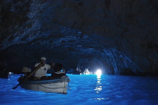 View from inside the blue lagoon, with passengers in a small rowing boat