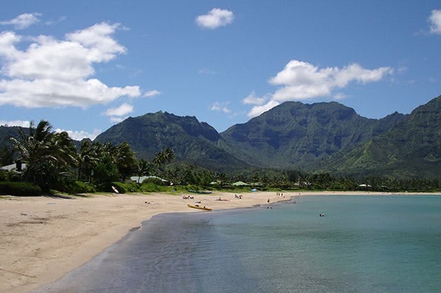 kauai beach with mountains in the distance in hawaii