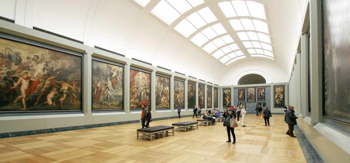 View inside an art gallery with the public looking at paintings