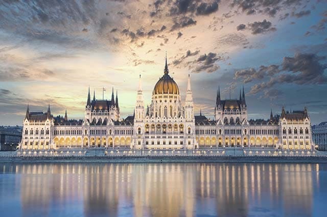 The grand hungarian parliament building lit up at night on the banks of the Danube 