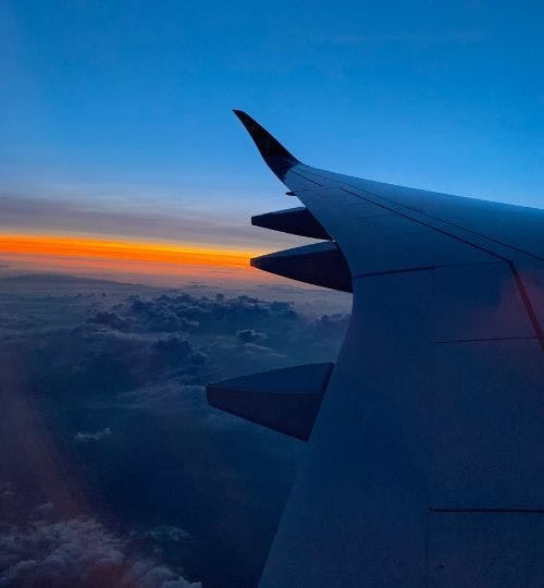 View of a plane wing at sunset