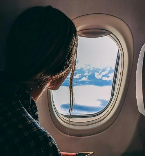 Lady looking out of a plane window