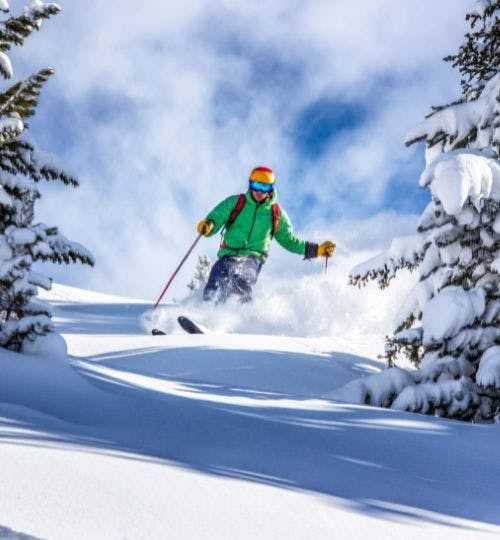 Man skiing down a snowy hill